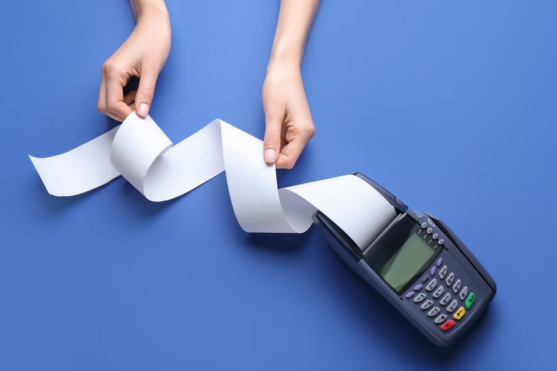 Female Hands with Payment Terminal on Color Background